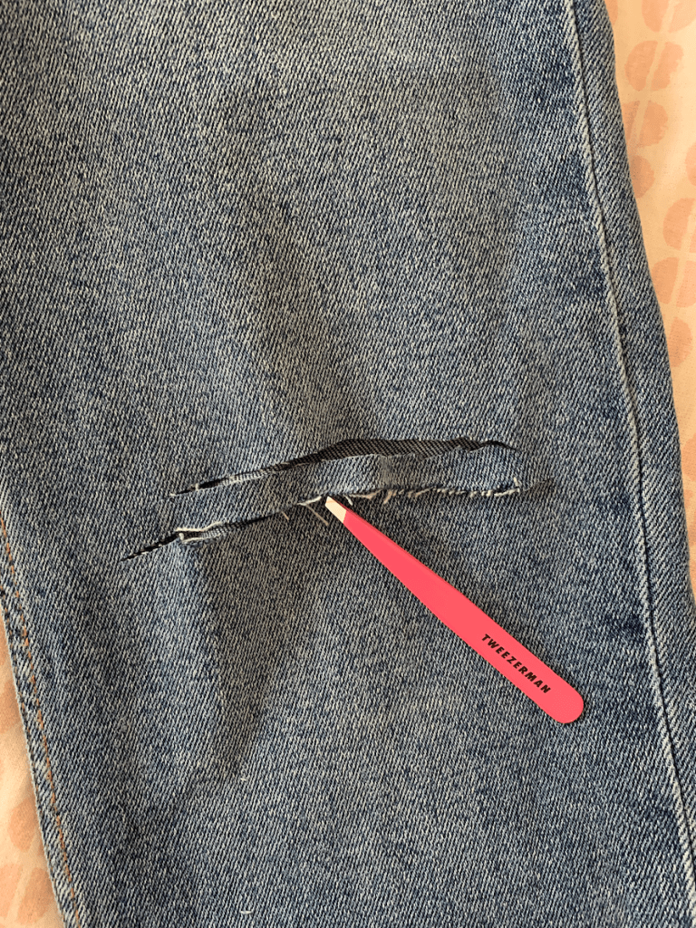 tweezers ripped jeans